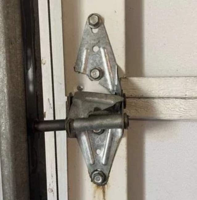 broken garage door hinge repair St. Louis MO